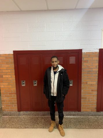 Freshman Alex James Johnson, also known as AJ, posing in the hallway
 