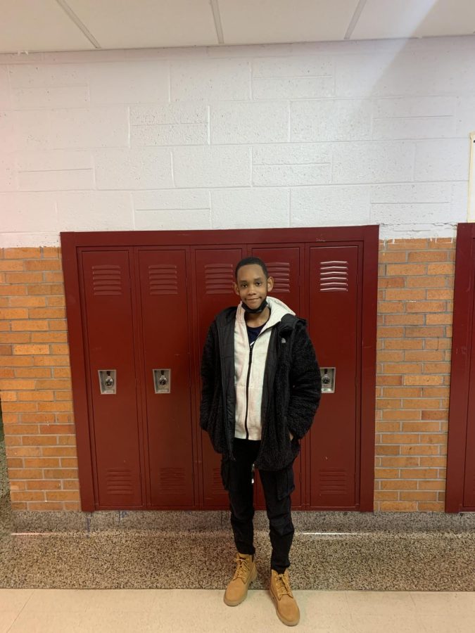 Freshman Alex James Johnson, also known as AJ, posing in the hallway
 