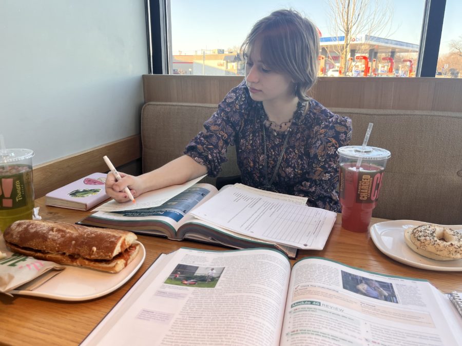 Senior Gray Garska completes a study guide for AP Psychology at a café. Study guides like these can later help students review for the AP exam!