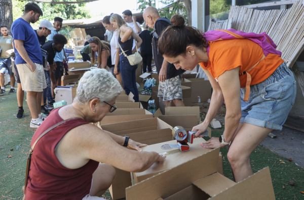 Volunteers prepare aid packages and supplies for Israeli soldiers and evacuated residents in Tel Aviv on October 12, 2023.