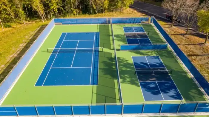 An area that was once two tennis courts, and now is one tennis court and two pickleball courts.