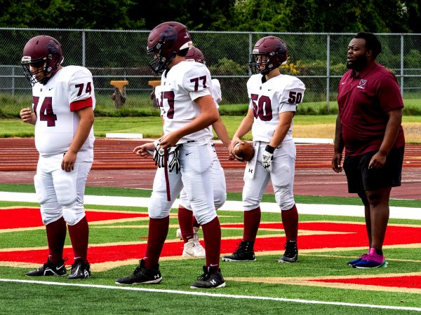 Malachi Bolden coaching the Defensive of Lineman before a game