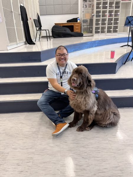 Service dog Korra with her owner Mr. Moy in his Orchestra classroom 