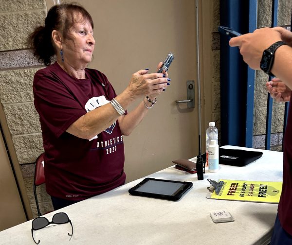 A Berkley athletic volunteer scanning in students with the GoFan app