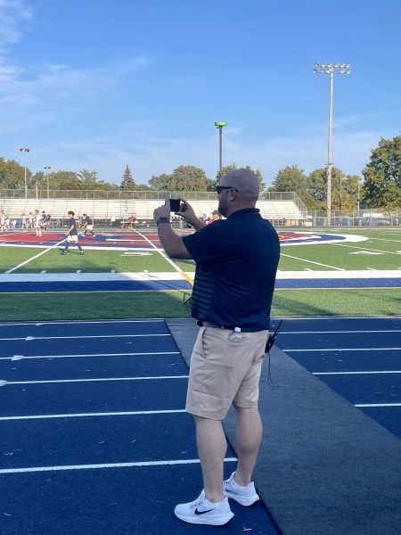 Mr. Rawlik captures image of the Boys Varsity Soccer Game to post to the athletic's Instagram page.