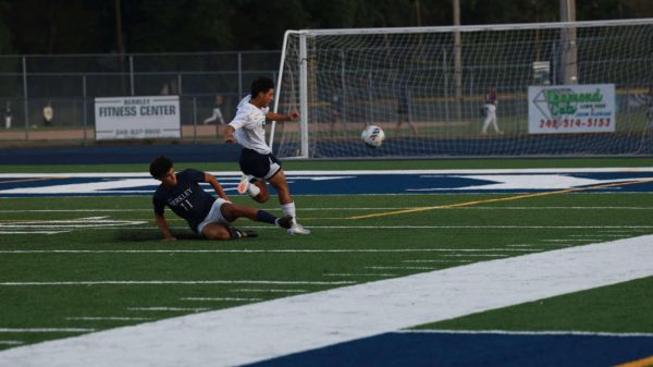 Captain Sam Niyo lunges for the ball through his opponent. 