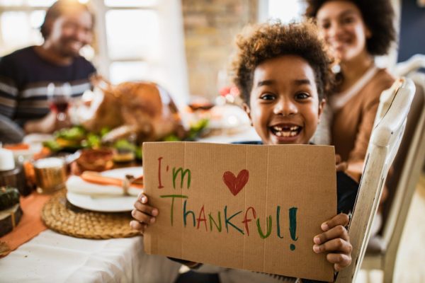 Child being thankful during Thanksgiving dinner