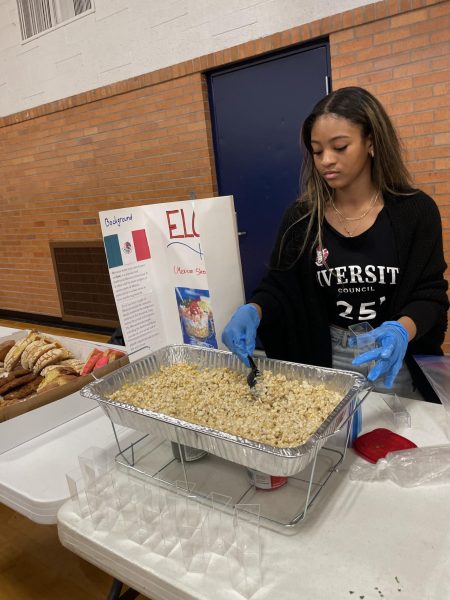 Taylor Ricks, a student in Diversity, serves street corn at Culture Fest