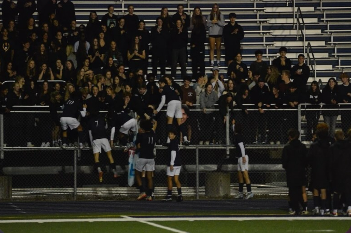 The Berkley Bears soccer team celebrating with the Bear Pack.