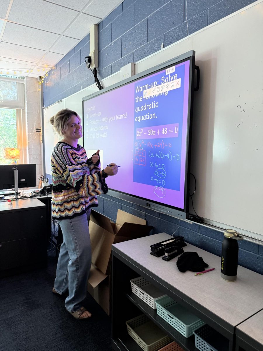 Mrs. Navarro teaching an Algebra 2 class at her board.