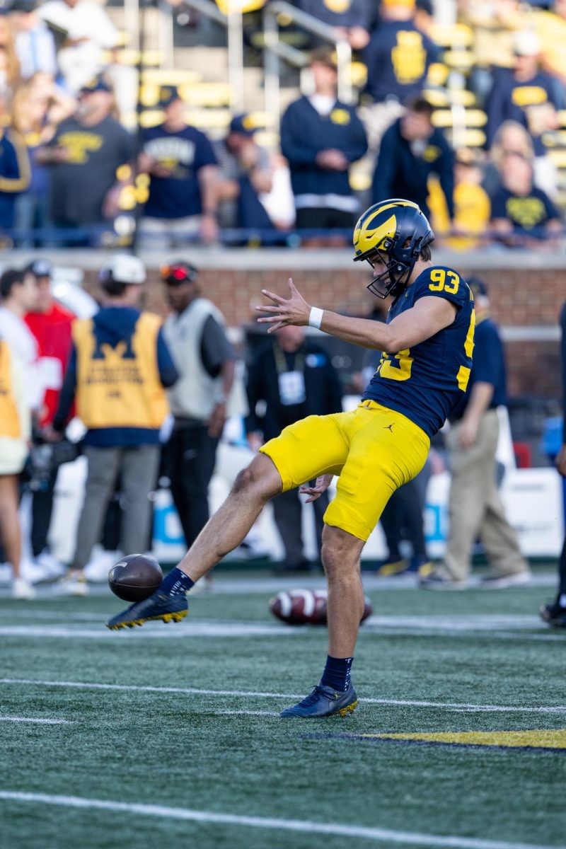 Hunter Robertson warming up for his first home football game vs New Mexico. Courtesy of University of Michigan Athletics.