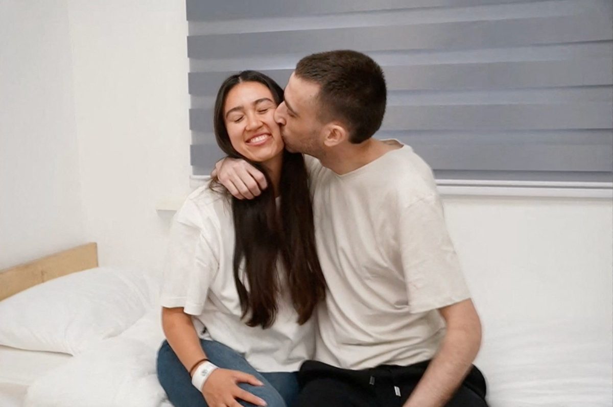 Released Israeli hostage, Avinatan Or, held in Gaza since the deadly October 7, 2023 attack by Hamas, kisses his girlfriend, Noa Argamani, who was also taken hostage and rescued in 2024, after his release as part of a prisoner-hostage swap and a ceasefire deal between Israel and Hamas, in Reim, Israel October 13, 2025. Courtesy of Israel Defense Forces/Handout via REUTERS