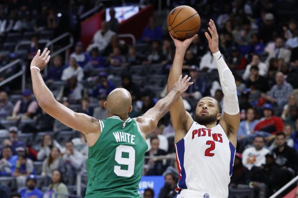 Oct 26, 2025; Detroit, Michigan, USA;  Detroit Pistons guard Cade Cunningham (2) shoots on Boston Celtics guard Derrick White (9) in the second half at Little Caesars Arena. Mandatory Credit: Rick Osentoski-Imagn Images