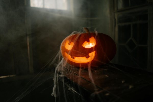 Halloween Jack-O-Lantern covered in spiderwebs. Credit: Pexels/Cottonbro