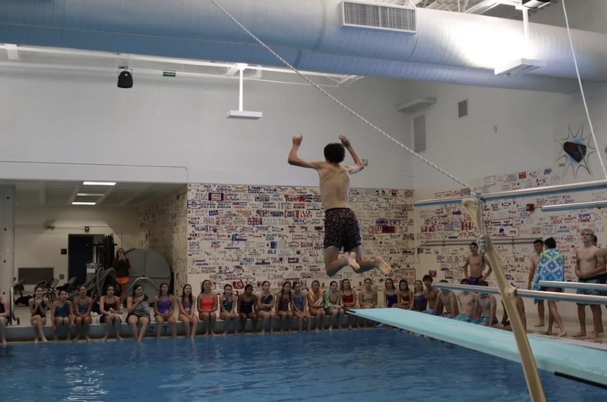 Junior Max Byers jumping off the diving board. (photo by Emmy Warner)