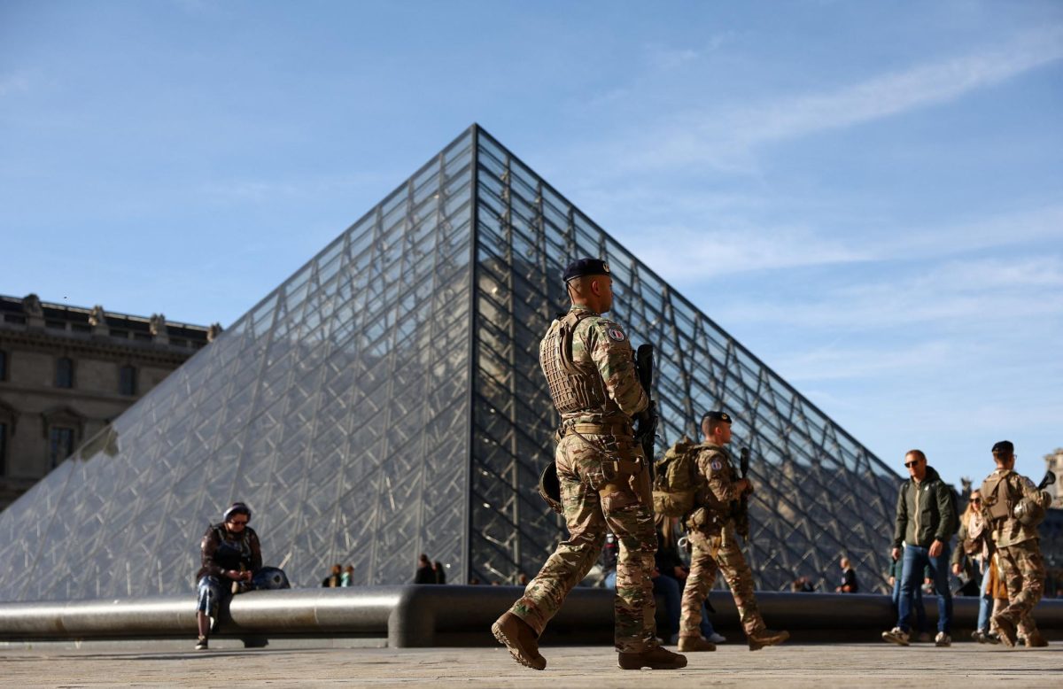 French soldiers from the "Sentinelle" security plan patrol past the glass Pyramid of the Louvre Museum as French police have arrested more suspects linked to the theft of treasures from the Louvre museum's Galerie d'Apollon (Apollo gallery), in Paris, France.