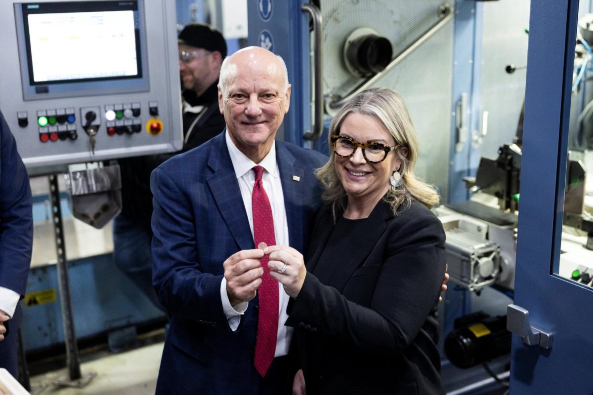 U.S. Treasurer Brandon Beach and Kristie McNally, Acting Director of The U.S. Mint, pose for a photo with the last struck penny, marking the end of 232 years of penny production in the United States, at the United States Mint in Philadelphia, Pennsylvania, U.S., November 12, 2025. 