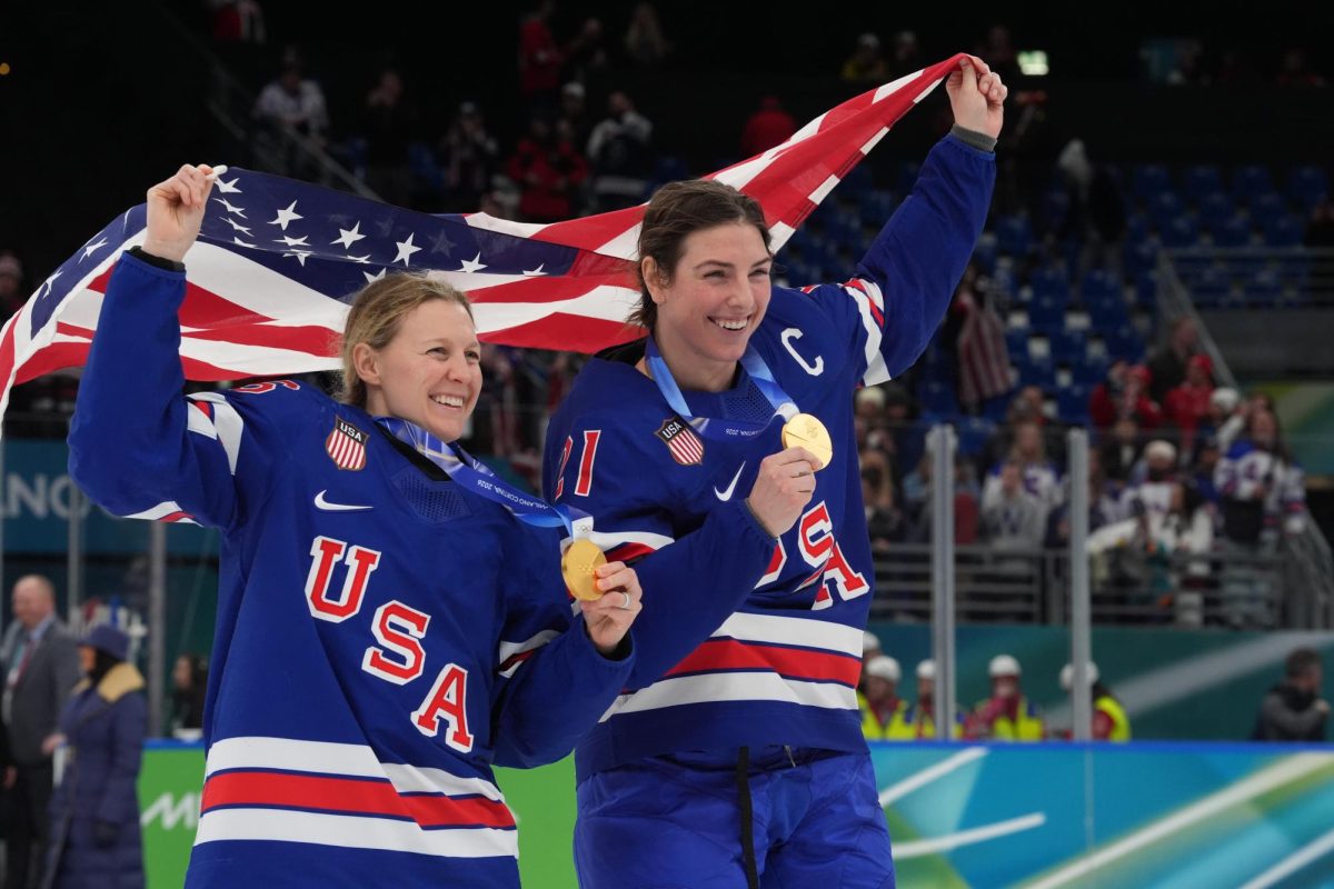 Feb 19, 2026; Milan, Italy; Kendall Coyne (26) of the United States and Hilary Knight (21) of the United States celebrate after winning the gold medal in women's ice hockey after defeating Canada during the Milano Cortina 2026 Olympic Winter Games at Milano Santagiulia Ice Hockey Arena. Mandatory Credit: Amber Searls-Imagn Images

