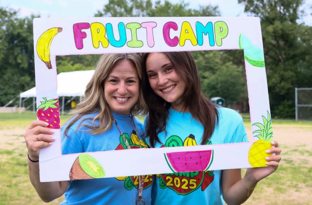 Lindsey Philko and her boss holding a Fruit Camp sign