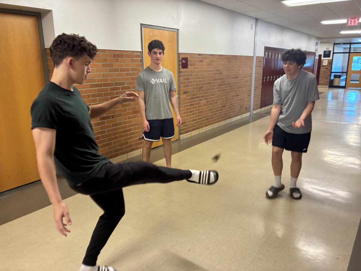 Hacky Sack allstars Cooper Arnoff, Paul Cascade, and Eli Kates practicing their skills.